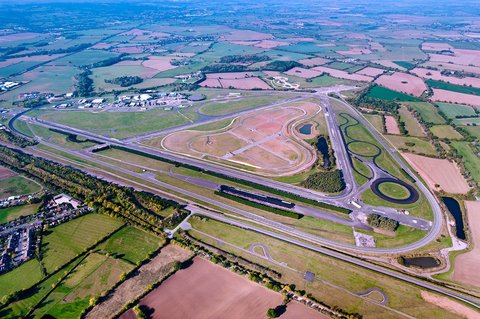 Illustrative reference image: an aerial view of a controlled-track environment