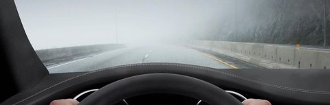 Illustrative reference image: driving conditions with rain and reduced visibility